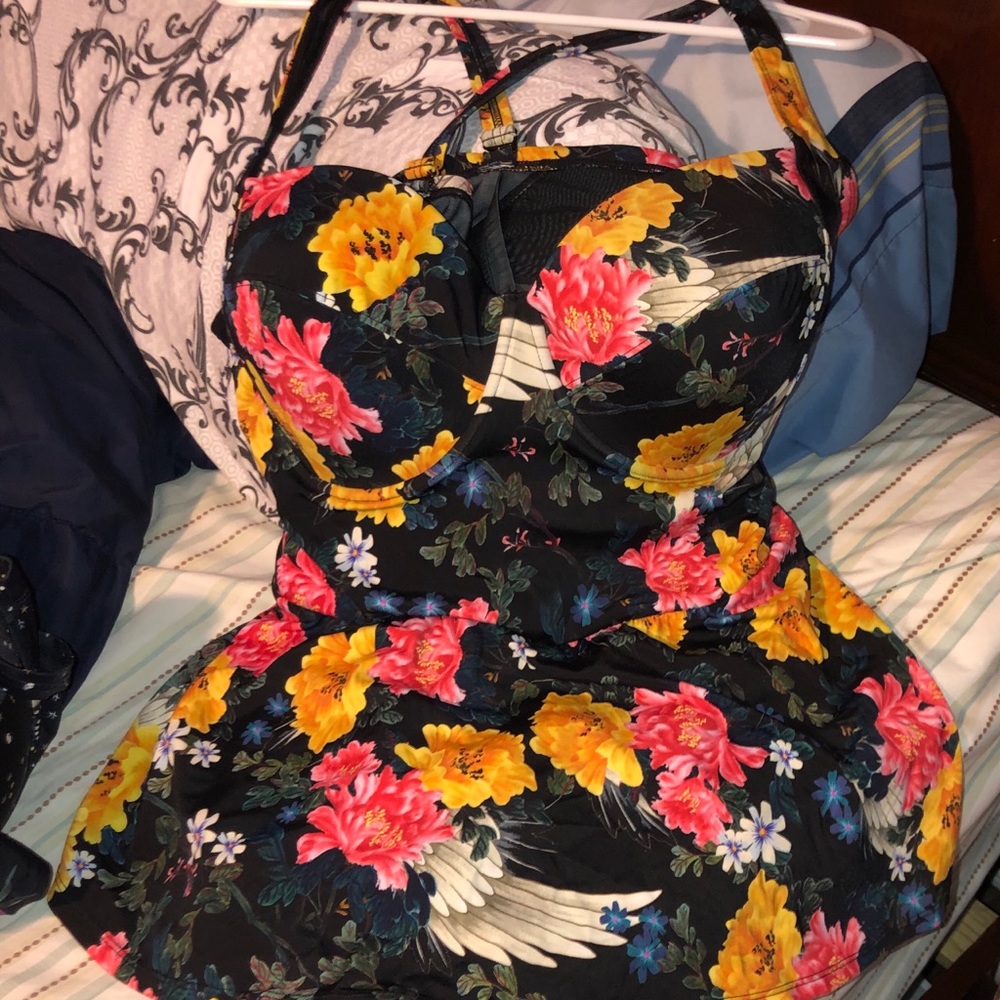 Torrid one piece swim suit with a skirt.
